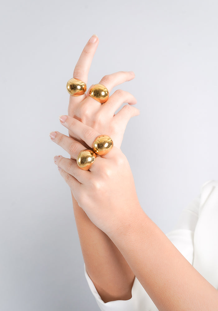 18K gold-plated statement rings featuring bold, spherical designs. A striking addition to elevate any look with modern elegance.