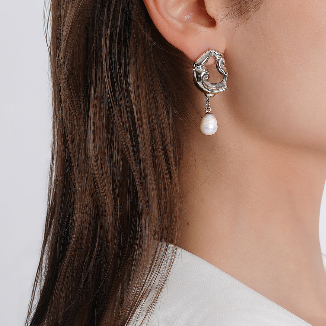 Silver earrings featuring elegant pearls, showcasing a sophisticated and timeless design.
