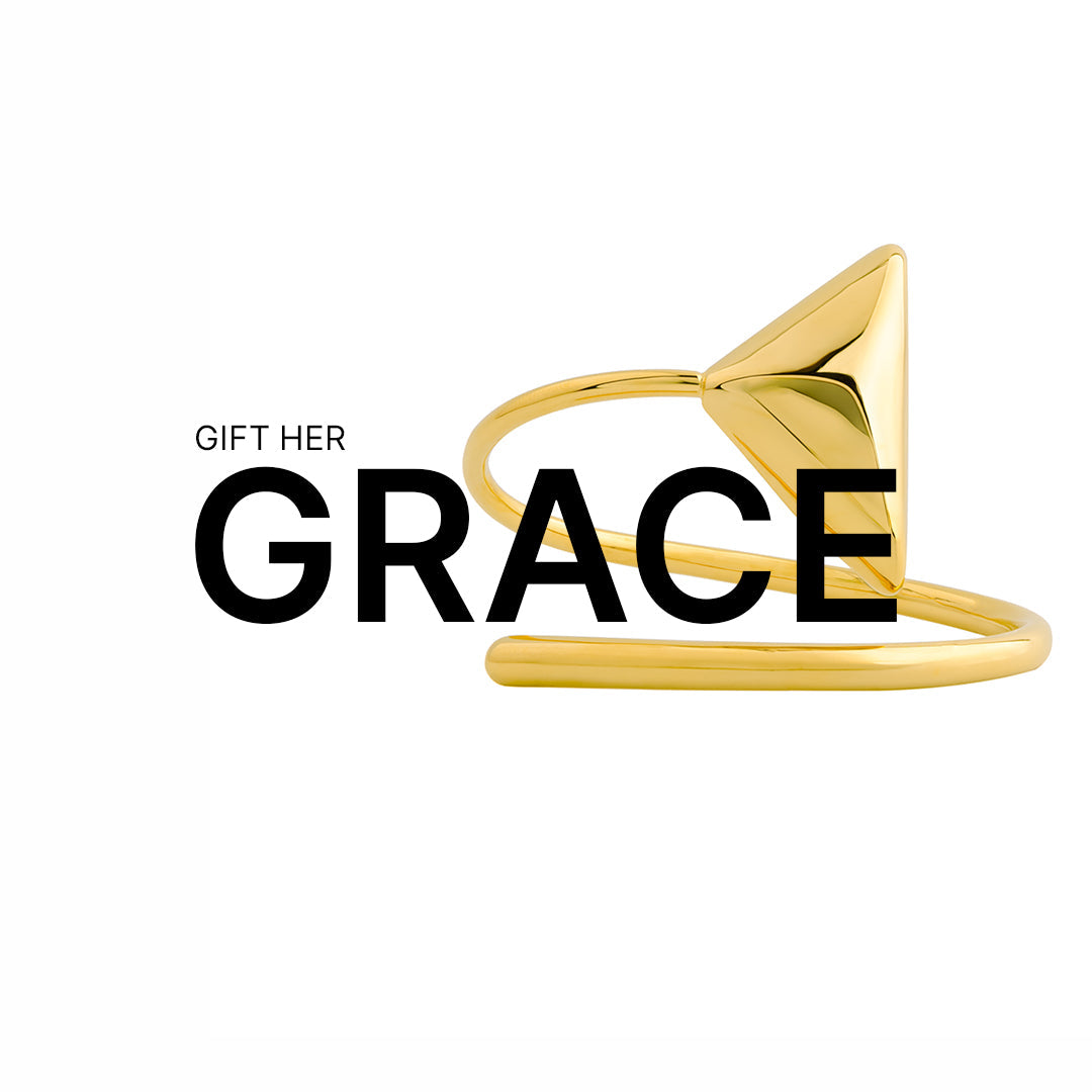 Sculptural 18K gold-plated open ring with a bold pyramid-shaped top, featured against a white background with the phrase "GIFT HER GRACE" where the sleek ring design weaves through the bold word "GRACE."