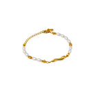 Gold and pearl bracelet on a white background