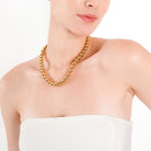 Model wearing an 18K gold-plated ball chain necklace with polished beads, adding a classic touch of elegance to her minimal outfit.