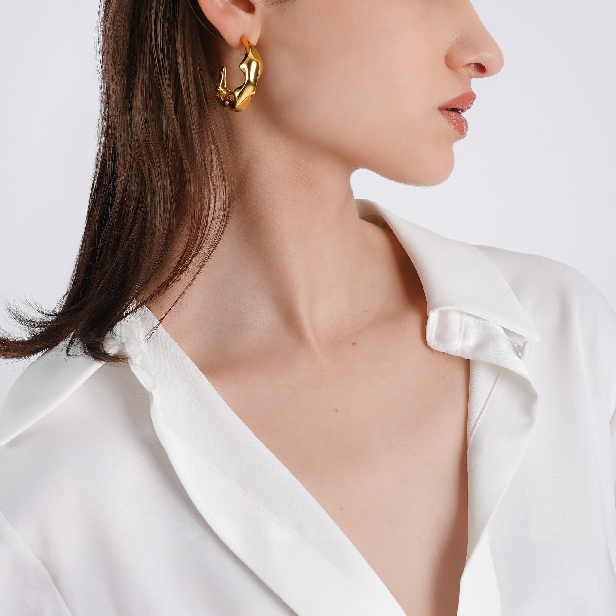 18K gold-plated organic hoop earrings with a bold sculptural texture, adding fluid elegance to any outfit.