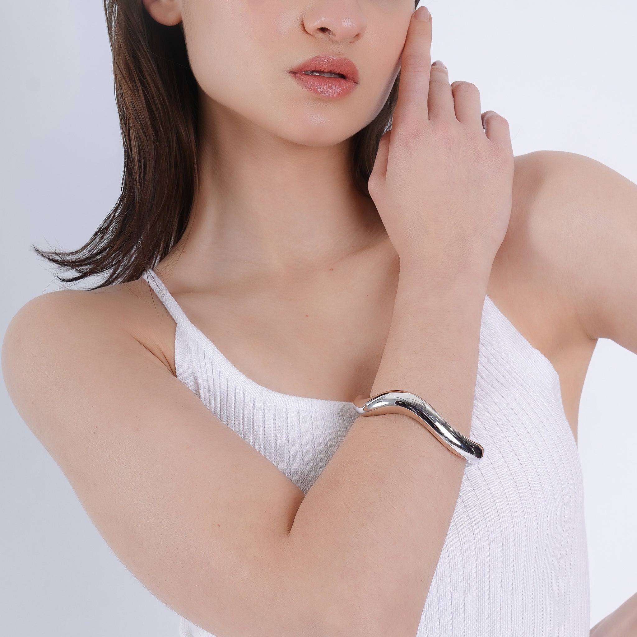 Silver plated open cuff bracelet, designed with a smooth, curved silhouette to exude contemporary charm and understated luxury.