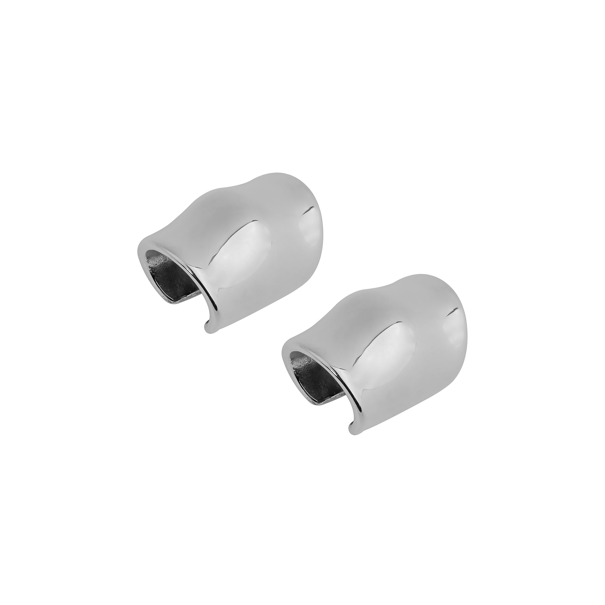 Close-up view of silver plated ear cuffs, showcasing their smooth, wavy, and contemporary design with a glossy finish.