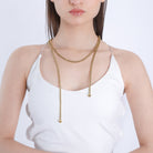 A model showcasing the gold-plated long chain accessory elegantly draped around the neck, adding a chic and polished look.
