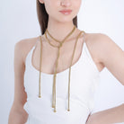 A model showcasing the gold-plated long chain accessory elegantly draped around the neck, adding a chic and polished look.