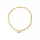 Close-up view of an 18K gold-plated chain necklace featuring interlocking links and a toggle clasp design, arranged neatly in a circular layout on a white background.