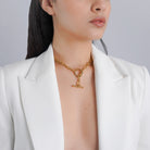 A model wearing the 18K gold-plated chain necklace with a toggle clasp resting elegantly on her neck, styled over a white blazer for a chic, modern look.