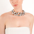 Model wearing the silver plated chunky chain choker with bold interlocking links, styled with a white blazer, highlighting its statement look and glamorous appeal.