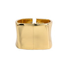 Close-up view of an gold-plated wide cuff bracelet, featuring a sleek, polished surface with a sturdy clasp mechanism, showcasing its modern, bold design and reflective finish.