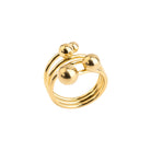 Close-up of an 18K gold-plated statement ring featuring stacked bands and polished gold spheres, creating a dynamic, contemporary design.