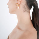 Model wearing 18K gold-plated hoop earrings with dangling pearls, styled to highlight their refined look and versatile elegance, perfect for both formal and casual wear.