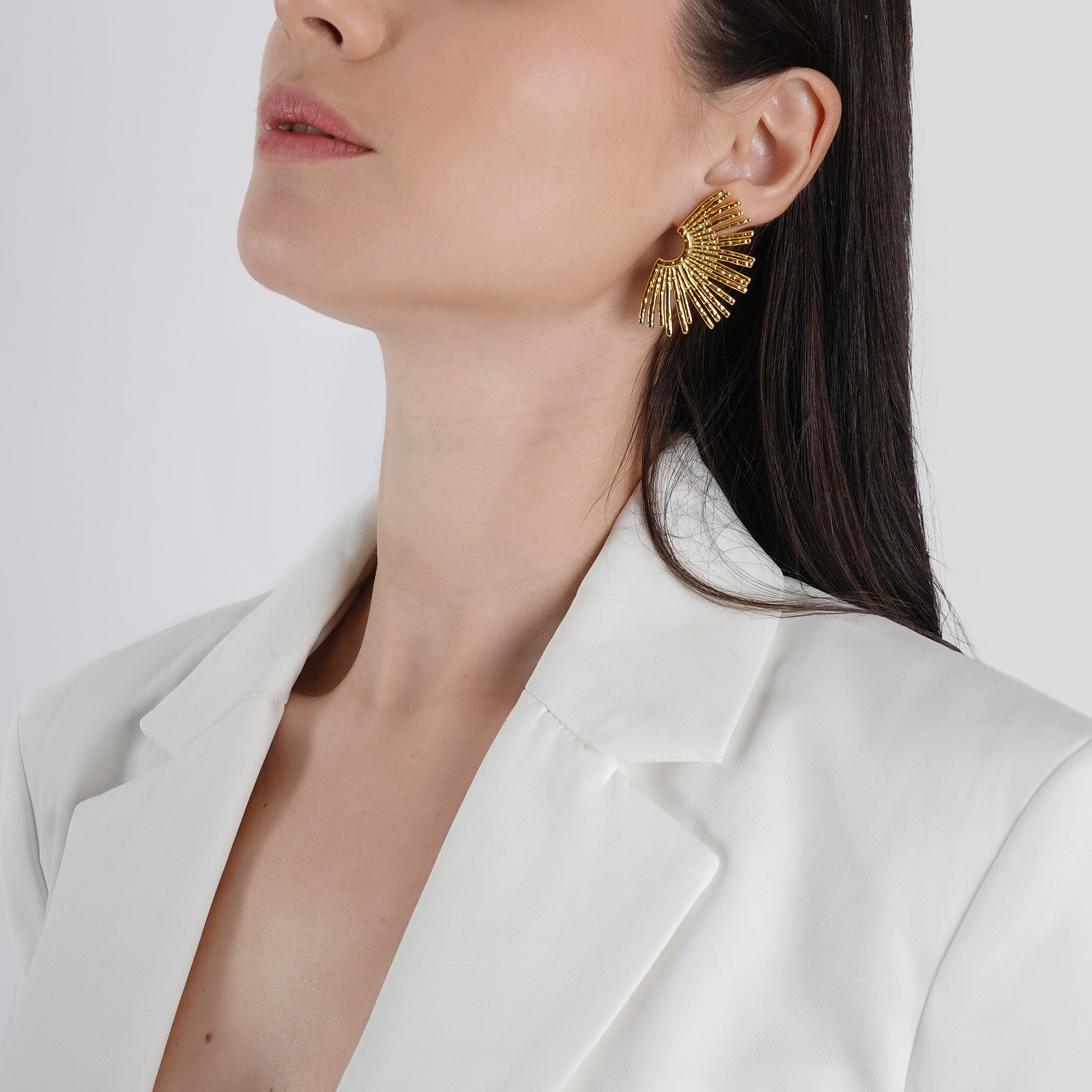 A model wearing the 18K gold-plated fan-shaped earrings, highlighting their statement design and elegant shine.
