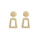 A pair of gold-plated, hammered geometric earrings featuring circular studs connected to open trapezoid pendants with a textured finish, exuding a bold and artistic design.