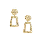 A pair of gold-plated, hammered geometric earrings featuring circular studs connected to open trapezoid pendants with a textured finish, exuding a bold and artistic design.