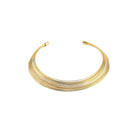 A sleek, multi-layered gold choker necklace composed of delicate, closely arranged wires creating a smooth, polished finish.