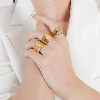 Bold 18K gold-plated textured rings with a statement-wide band design. Featuring an organic, hammered finish that exudes modern elegance, these rings are perfect for stacking or wearing individually for a striking look.
