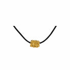 Talisman Necklace, 22K gold plated charm on adjustable black cord.
