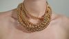A beautiful woman wearing a 18K Gold necklace.