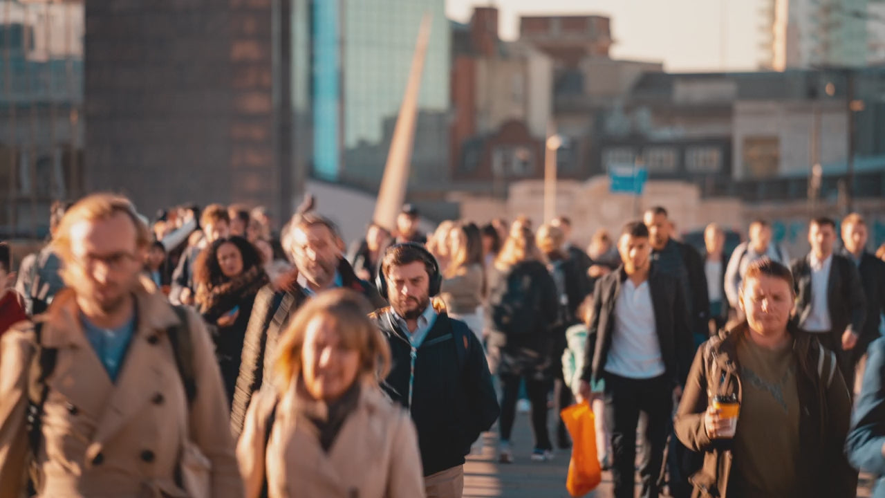 A time-lapse capturing the hustle and bustle of commuters crowding the streets during rush hour.